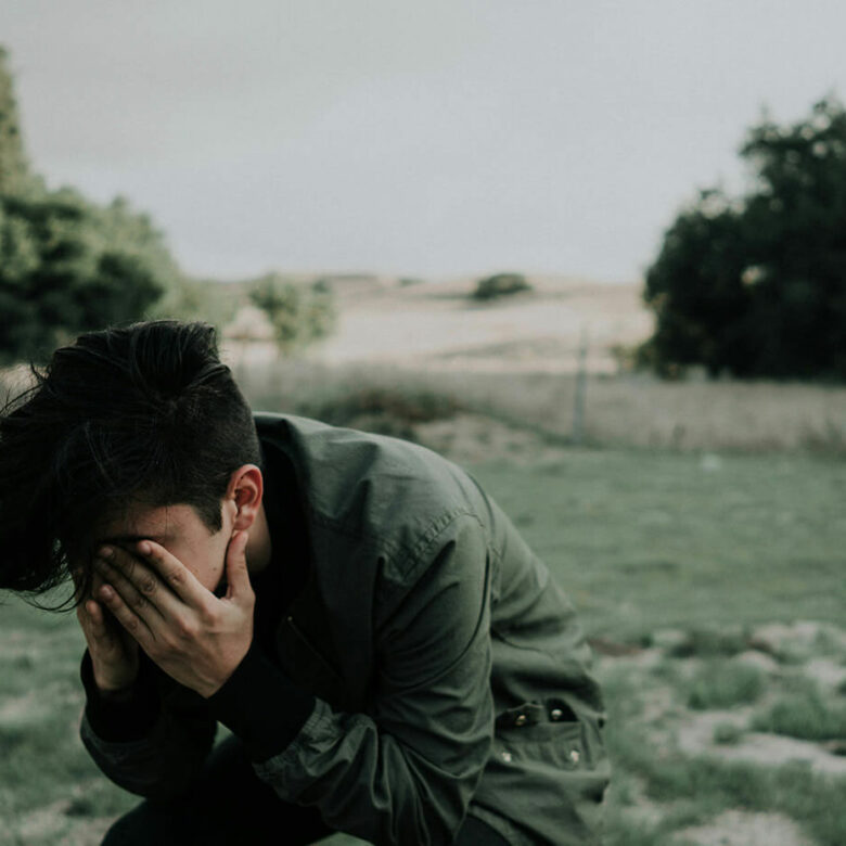 Boy holding head in hands